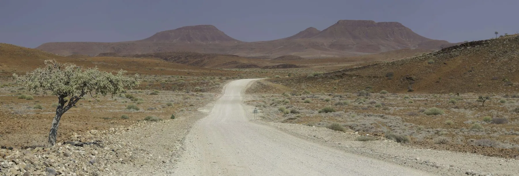 A gravel road running through the dry hills of Damaraland