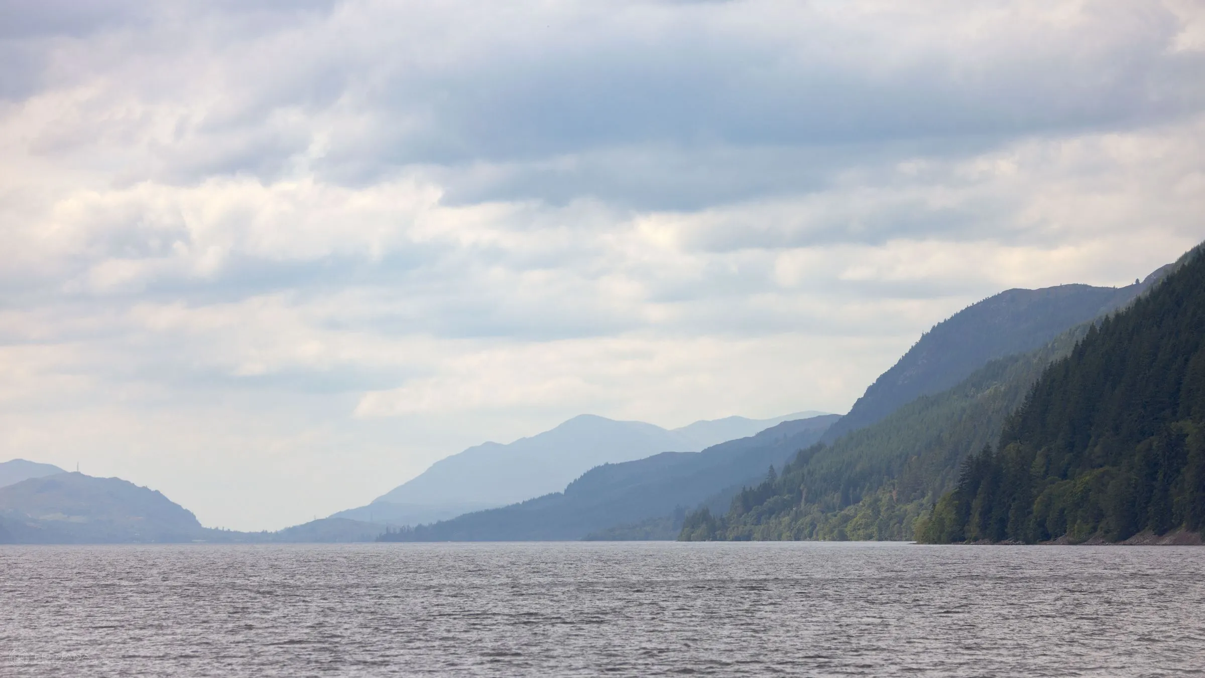 Loch Ness stretching away between wooded hills